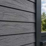 Close-up of textured double embossed cladding on a building with a blurred natural background